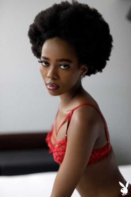 Ebony Playboy model Alicia stripping off