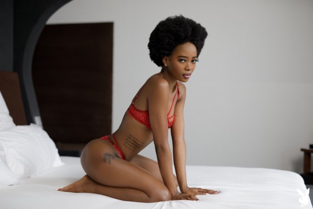 Ebony Playboy model Alicia stripping off