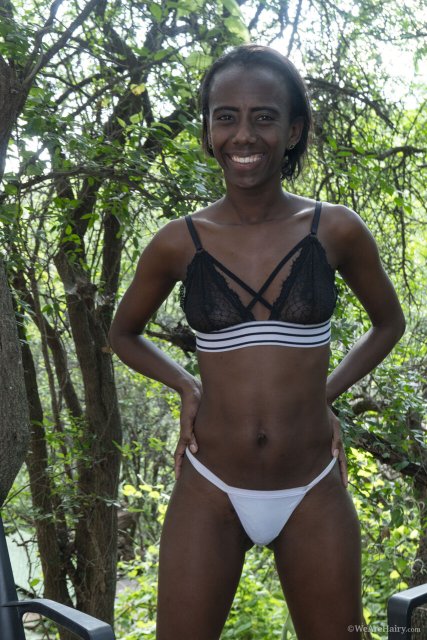 Black petite Luz M baring hairy pussy